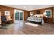 Comfortable bedroom featuring wood-finished walls and a sliding glass door to the outside at 57 Overlook Ct, Idaho Springs, CO 80452