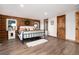 Cozy bedroom with log walls, a large bed, and natural light from the windows at 57 Overlook Ct, Idaho Springs, CO 80452
