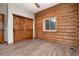 Unfurnished bedroom with wood beam walls and sliding barn door at 57 Overlook Ct, Idaho Springs, CO 80452