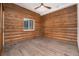 Unfurnished bedroom with wooden walls, wooden floors and a ceiling fan at 57 Overlook Ct, Idaho Springs, CO 80452