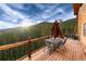 Outdoor deck with stunning views of mountain landscape and seating area with table and chairs at 57 Overlook Ct, Idaho Springs, CO 80452