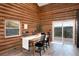 Dining area features wood walls, mountain views, and sliding glass door at 57 Overlook Ct, Idaho Springs, CO 80452