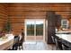 Dining room featuring log walls, view, and modern kitchen with island at 57 Overlook Ct, Idaho Springs, CO 80452