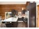 Modern kitchen features a quartz countertop island, stainless steel appliances, and opens to the dining area with forest views at 57 Overlook Ct, Idaho Springs, CO 80452