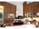 Cozy living room with a modern fireplace, wood walls, and comfortable seating for relaxing and enjoying the surroundings at 57 Overlook Ct, Idaho Springs, CO 80452