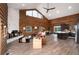 Spacious living room features wood walls, vaulted ceilings, a stone fireplace, and views of the surrounding forest at 57 Overlook Ct, Idaho Springs, CO 80452