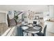 Modern dining area with black table and gray chairs, open to kitchen at 17693 Elati St, Broomfield, CO 80023