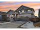 Two-story house with gray siding, stone accents, and a two-car garage at 17693 Elati St, Broomfield, CO 80023