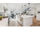 Modern kitchen with white cabinets, large island, and stainless steel appliances at 17693 Elati St, Broomfield, CO 80023