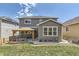 Exterior home view with covered patio and well-maintained yard at 10863 Endeavor Dr, Parker, CO 80134