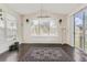 Bright dining room with dark wood floors, a decorative rug, and a modern chandelier at 10863 Endeavor Dr, Parker, CO 80134