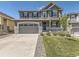Beautiful two-story home featuring a well-manicured lawn and a two-car garage at 10863 Endeavor Dr, Parker, CO 80134