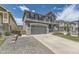 Charming two-story home with a gray exterior, a spacious driveway and a manicured front yard at 10863 Endeavor Dr, Parker, CO 80134