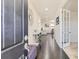 Elegant foyer with dark hardwood floors, a decorative mirror and a view into the living spaces at 10863 Endeavor Dr, Parker, CO 80134