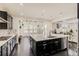 Bright, modern kitchen with a large island, stainless steel appliances, and hardwood flooring at 10863 Endeavor Dr, Parker, CO 80134