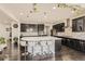 Stylish kitchen featuring dark wood cabinetry, a large center island, and modern appliances at 10863 Endeavor Dr, Parker, CO 80134