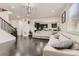 Spacious living room with hardwood floors, a modern sofa and a view to the kitchen at 10863 Endeavor Dr, Parker, CO 80134