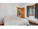 Bedroom featuring neutral walls, wood trim and view into the open stairway at 26196 Rea Ave, Conifer, CO 80433