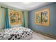 Cozy bedroom with neutral walls and two windows for ample natural light at 26196 Rea Ave, Conifer, CO 80433