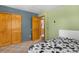 Bedroom includes closet space and view to connected ensuite bathroom at 26196 Rea Ave, Conifer, CO 80433