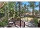 Spacious deck with seating and beautiful views of the surrounding wooded area and natural landscape at 26196 Rea Ave, Conifer, CO 80433
