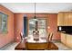 Cozy dining room with natural light and outdoor views through a sliding glass door at 26196 Rea Ave, Conifer, CO 80433