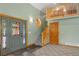 Inviting foyer with a grey front door, light green walls, and a cozy loft area above at 26196 Rea Ave, Conifer, CO 80433