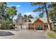 Inviting home exterior with a well-manicured yard, two-car garage, and charming front entrance at 26196 Rea Ave, Conifer, CO 80433