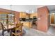 Bright eat-in kitchen featuring wooden cabinetry and access to the outside deck and yard at 26196 Rea Ave, Conifer, CO 80433