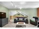 Spacious living room featuring modern furnishings, a green accent wall and a loft area view at 26196 Rea Ave, Conifer, CO 80433