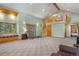 Spacious living room with vaulted ceilings, large windows, and a cozy wood-burning stove at 26196 Rea Ave, Conifer, CO 80433