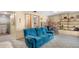 Comfortable living room with a brick fireplace and a plush blue sofa at 26196 Rea Ave, Conifer, CO 80433