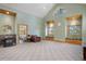 Inviting living room with large windows, custom built-ins, and a charming wood-burning stove at 26196 Rea Ave, Conifer, CO 80433