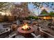 Cozy up by the fire pit surrounded by mature trees and the tranquil sounds of the nearby waterfall in this backyard oasis at 6402 E Cornell Ave, Denver, CO 80222