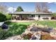 Backyard with a covered patio, outdoor seating, an outdoor kitchen, and a koi pond at 6402 E Cornell Ave, Denver, CO 80222