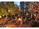 A custom fire pit and ample seating creates the perfect ambiance with custom lighting and a serene waterfall feature at 6402 E Cornell Ave, Denver, CO 80222