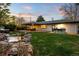 An entertainer's dream backyard features a stone waterfall, built-in bar, and covered patio with ample seating at 6402 E Cornell Ave, Denver, CO 80222
