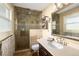 Well-appointed bathroom features a tiled walk-in shower and double sink vanity at 6402 E Cornell Ave, Denver, CO 80222