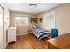 Bright bedroom with hardwood floors, a large window, and ample space for furniture at 6402 E Cornell Ave, Denver, CO 80222