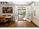Dining area with wood table and chairs, and an open door to the outside patio at 6402 E Cornell Ave, Denver, CO 80222