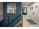 Entrance foyer featuring a large mirror and access to the lower level at 6402 E Cornell Ave, Denver, CO 80222