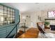 Stylish foyer with hardwood floors, designer mirror and a cozy chair at 6402 E Cornell Ave, Denver, CO 80222
