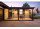 Inviting front porch with seating area and decorative lighting at 6402 E Cornell Ave, Denver, CO 80222