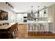 Bright kitchen with stainless steel appliances, white cabinetry, and a breakfast bar at 6402 E Cornell Ave, Denver, CO 80222