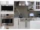 Stainless steel microwave and oven with stove range and stainless vent hood at 6402 E Cornell Ave, Denver, CO 80222