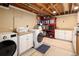 Well-organized laundry room features a front load washer and dryer and ample storage space at 6402 E Cornell Ave, Denver, CO 80222