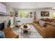 Open living room with accent chairs, sofa and decorative fireplace at 6402 E Cornell Ave, Denver, CO 80222