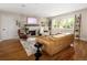 Bright living room features hardwood floors, fireplace, and a wall of windows for natural light at 6402 E Cornell Ave, Denver, CO 80222