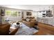 Open-concept living space boasts hardwood floors and seamless flow to the updated kitchen at 6402 E Cornell Ave, Denver, CO 80222