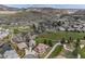 Overhead view of homes situated near a golf course, complete with ponds and a meandering stream, showing community landscaping at 16226 River Haven Way, Morrison, CO 80465